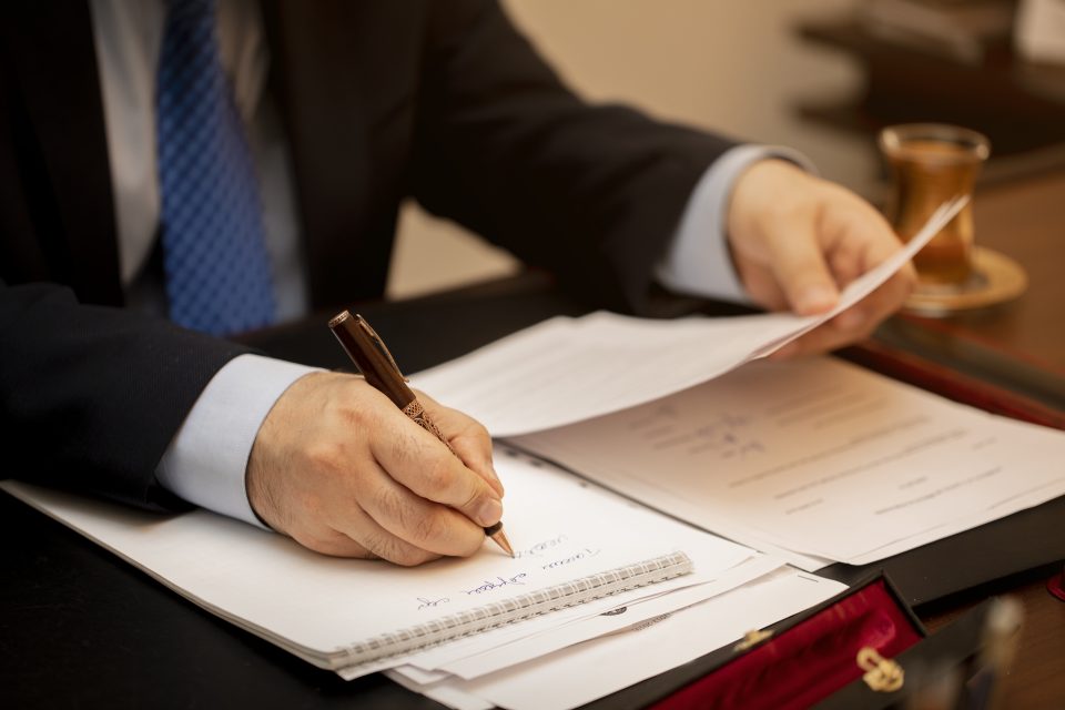 businessman signing important contract papers